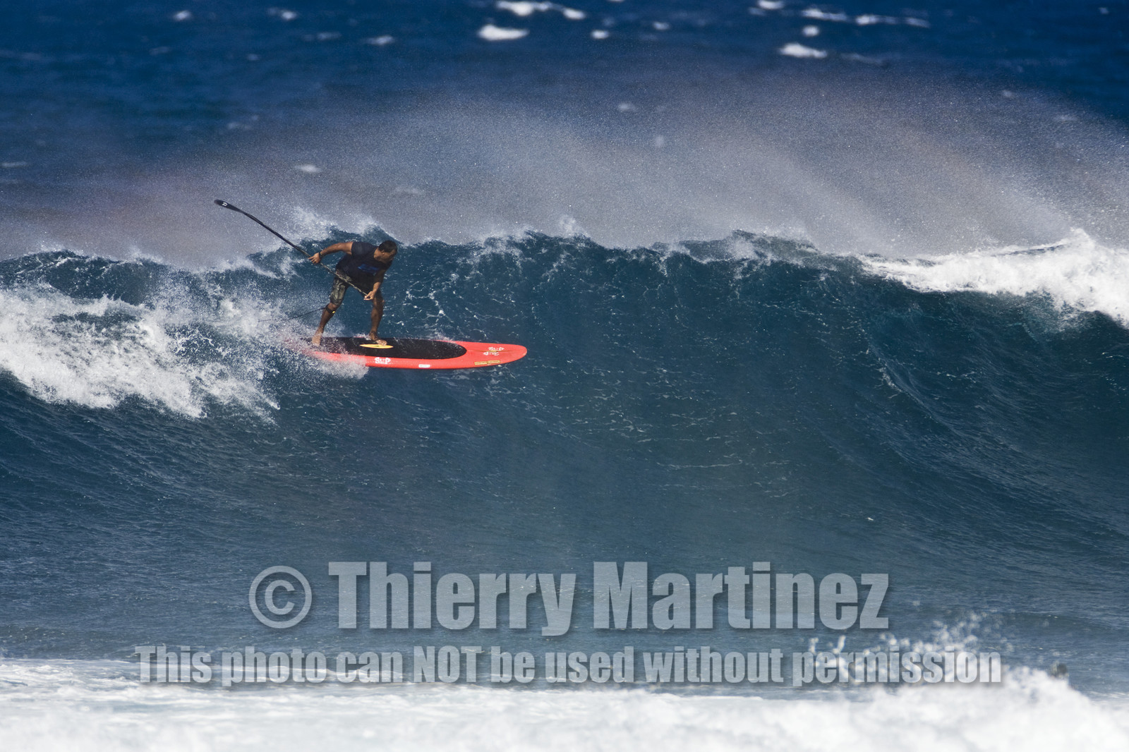Stand Up Paddle  in waves at Hookip'a Beach - North Shore Maui - Hawaii.
