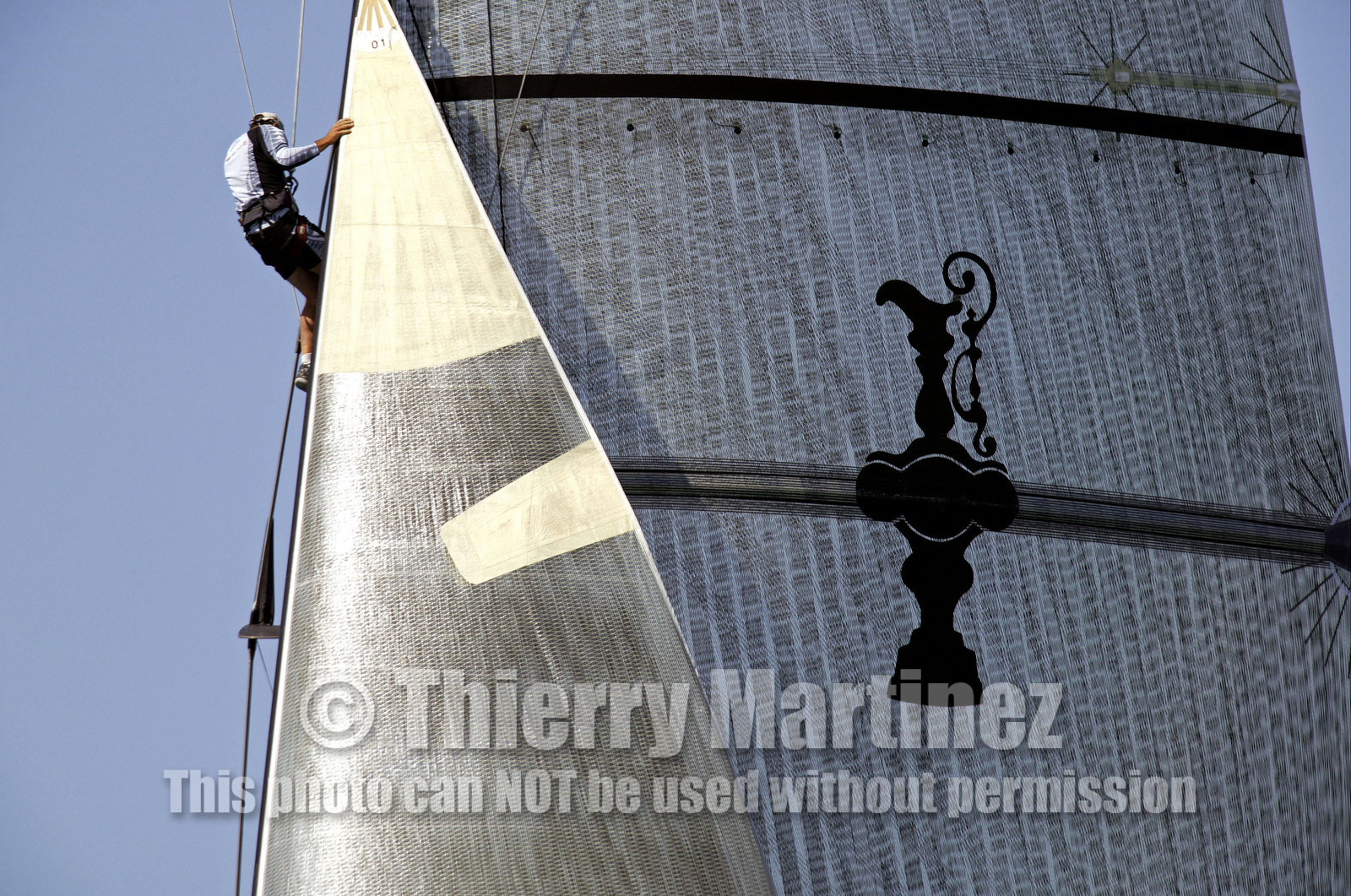 03_0205D ©Th.Martinez - Auckland (NZ) . America's Cup 2003. 18th February 2003. Day 2..Alinghi (SUI 64) vs Team NZ (NZL 82) .Team NZ's traveller Nick Heron in NZL 82  mast during pretsart of race 2....