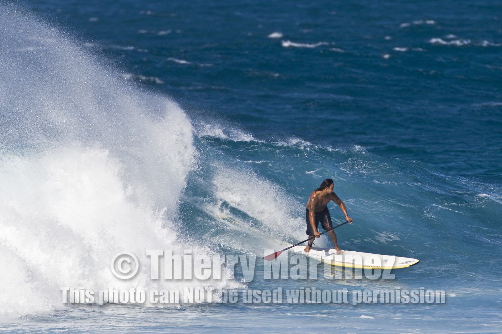 Stand Up Paddle  in waves at Hookip'a Beach - North Shore Maui - Hawaii.