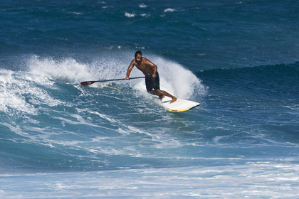 Stand Up Paddle  in waves at Hookip'a Beach - North Shore Maui - Hawaii.