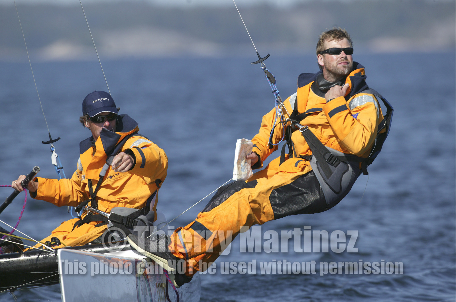 03_3064D © Th.Martinez,STOCKHOLM ARCHIPELAGO SWEDEN, 8 07 03-Archipelago Raid (2003)  Day 1..TIDERMANS   Anders Lewander (SWE)- at the helm and Calle Hendix (SWE) at the navigation on trapeze..Archipelago Raid = navigation.