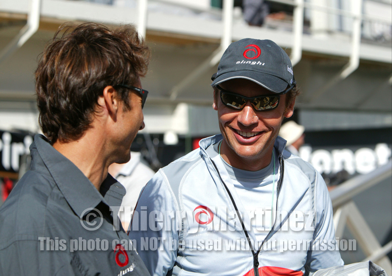 03_0873D © Th.Martinez. Auckland   New Zealand. 15 02 03 America's Cup Day 1.Alinghi (SUI64) vs Team New Zealand (NZL82)Alinghi Team onboard SUI64 leaving the dock for the first race day of the .America's Cup 2003. Ernesto Bertarelli, talking with bowman Bernard Labro before he leave the dock.