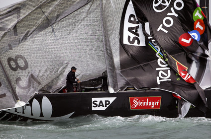 03_0254D ©Th.Martinez - Auckland (NZ) . America's Cup 2003. 28th February 2003. Day 4 .Alinghi (SUI 64) vs Team NZ (NZL 82) .Team NZ's boat dismast 57 minutes after the start in only 18 knots of windwith a swell of 1.5 m. Dean Barker still at the helm, with main sail and mast on deck. Alinghi is leading Team NZ  4-0 after 4 races.