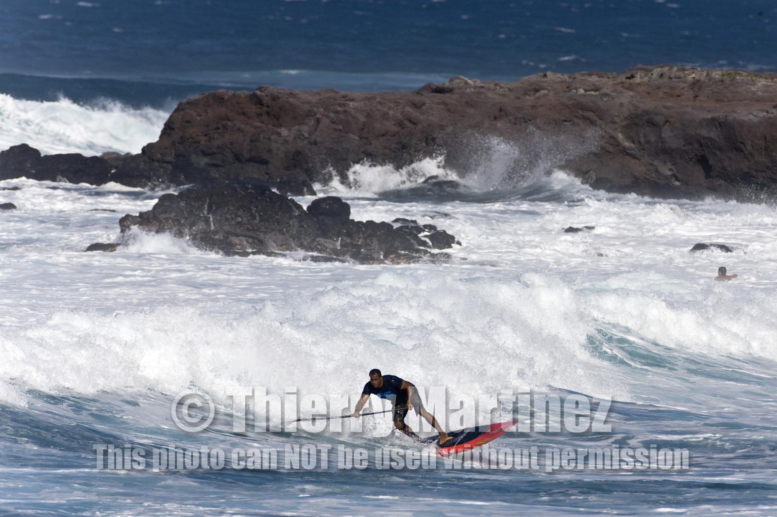 Stand Up Paddle  in waves at Hookip'a Beach - North Shore Maui - Hawaii.