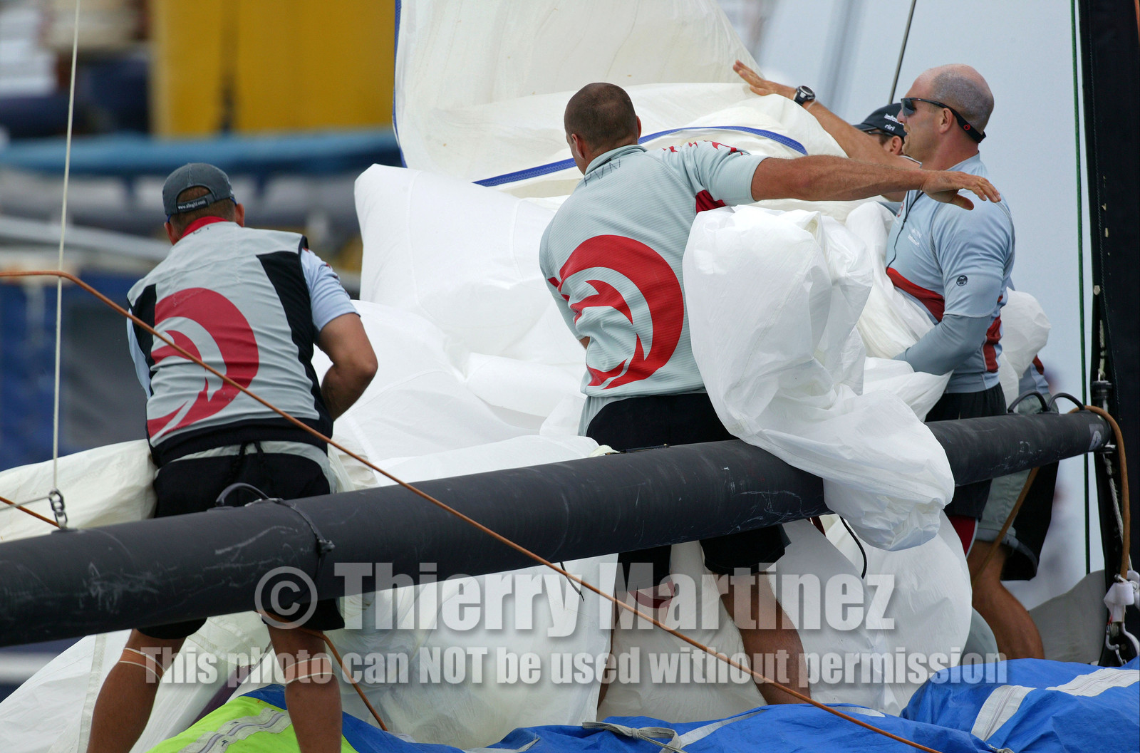 03_1012D © Th.Martinez . Auckland   New Zealand. 20th February 2003 America's Cup 2003, Day 4 Race cancelled Alinghi(SUI64) vs Team New Zealand(NZL82) Crew  dropping the spinnaker.