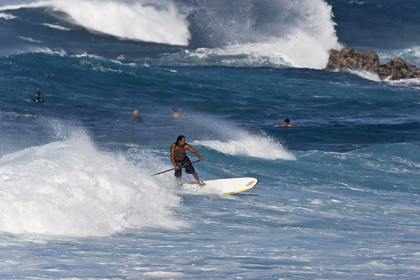 Stand Up Paddle  in waves at Hookip'a Beach - North Shore Maui - Hawaii.