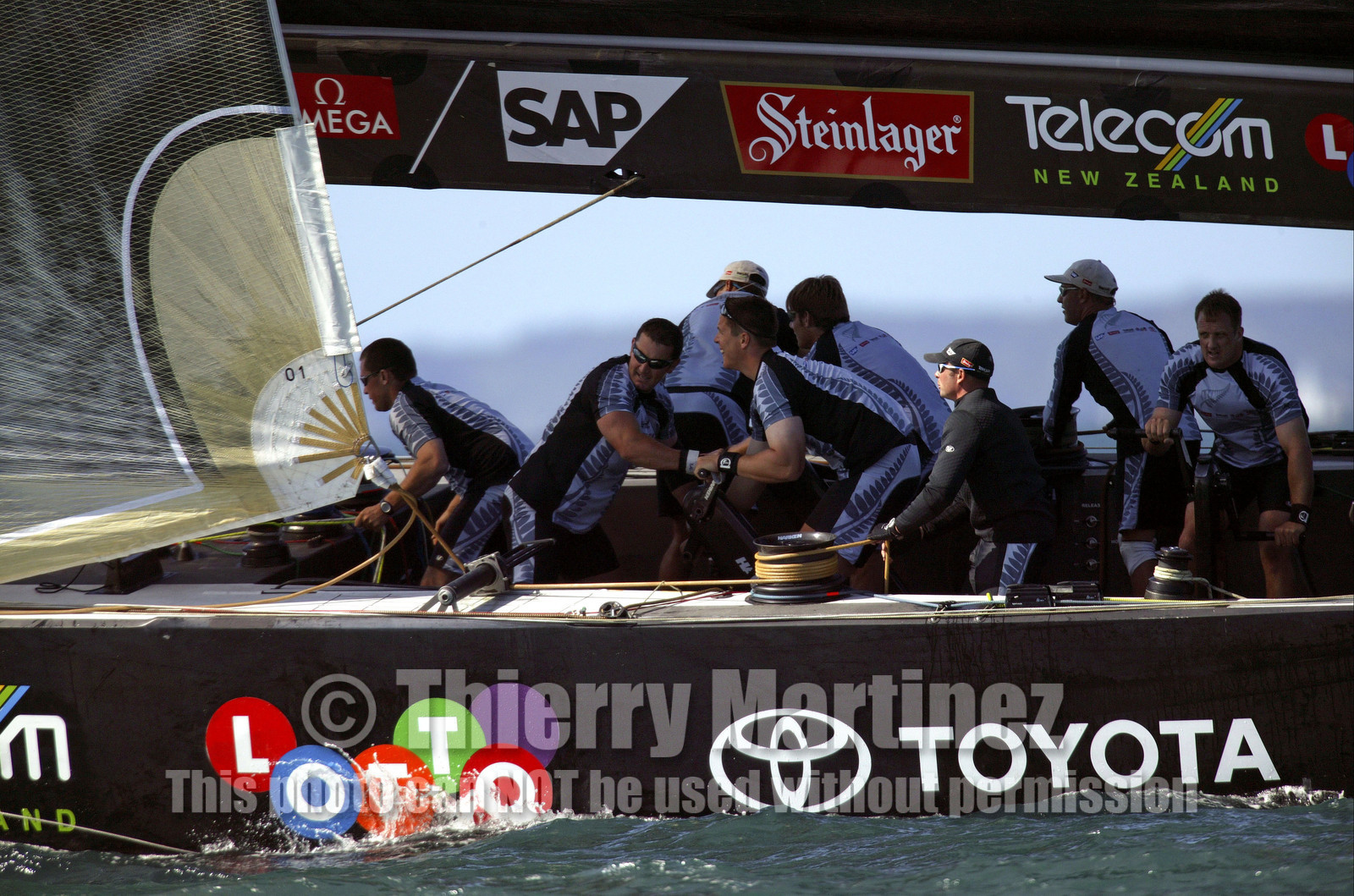 03_0211D ©Th.Martinez - Auckland (NZ) . America's Cup 2003. 18th February 2003. Day 2..Alinghi (SUI 64) vs Team NZ (NZL 82)  NZL 82's crew trimming Genoa after downwind mark...