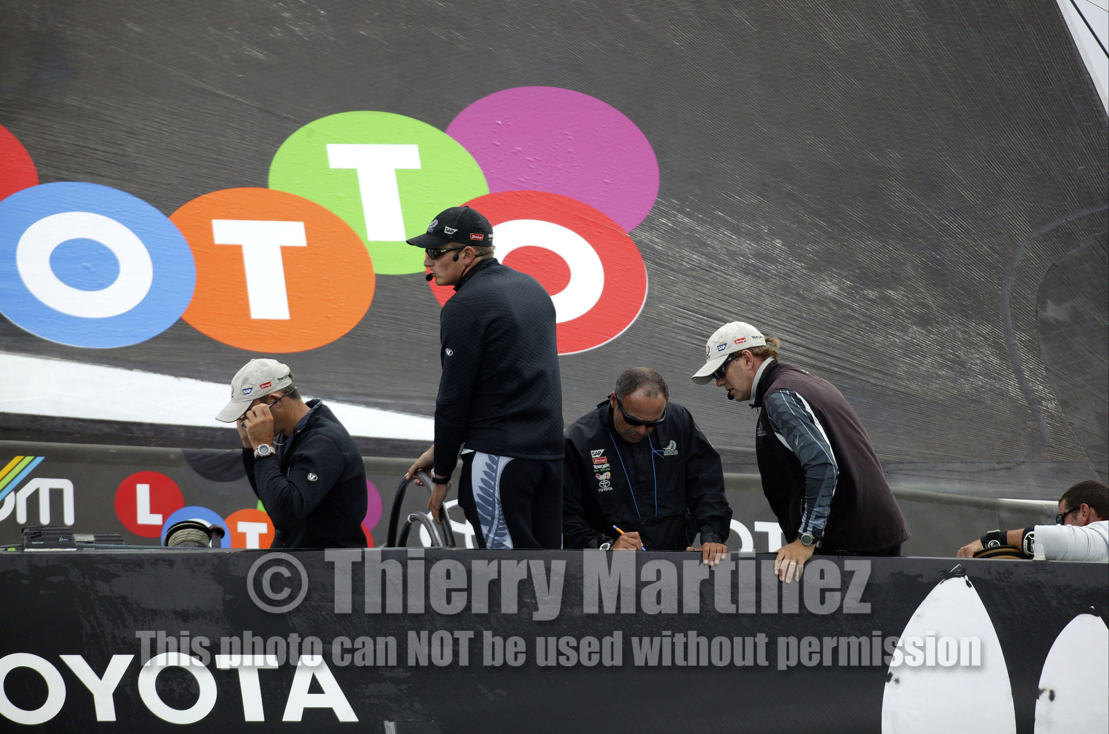 03_0243D ©Th.Martinez - Auckland (NZ) . America's Cup 2003. 20th February 2003. Day 4 Cancelled..Alinghi (SUI 64) vs Team NZ (NZL 82) .Team NZ's skipper Dean Barker at the helm of NZL 82, with frenchman Bertrand Pace , just behind Dean Barker,(Tactician, on place of Hamish Pepper) for first time on board for America's Cup. Bertrand Pace is the first French sailor to race in n America's Cup match and is the helmsman of NZL 81. The race had been cancelled for wind not enough stable. Race 4 should start on Saturday 22th February...