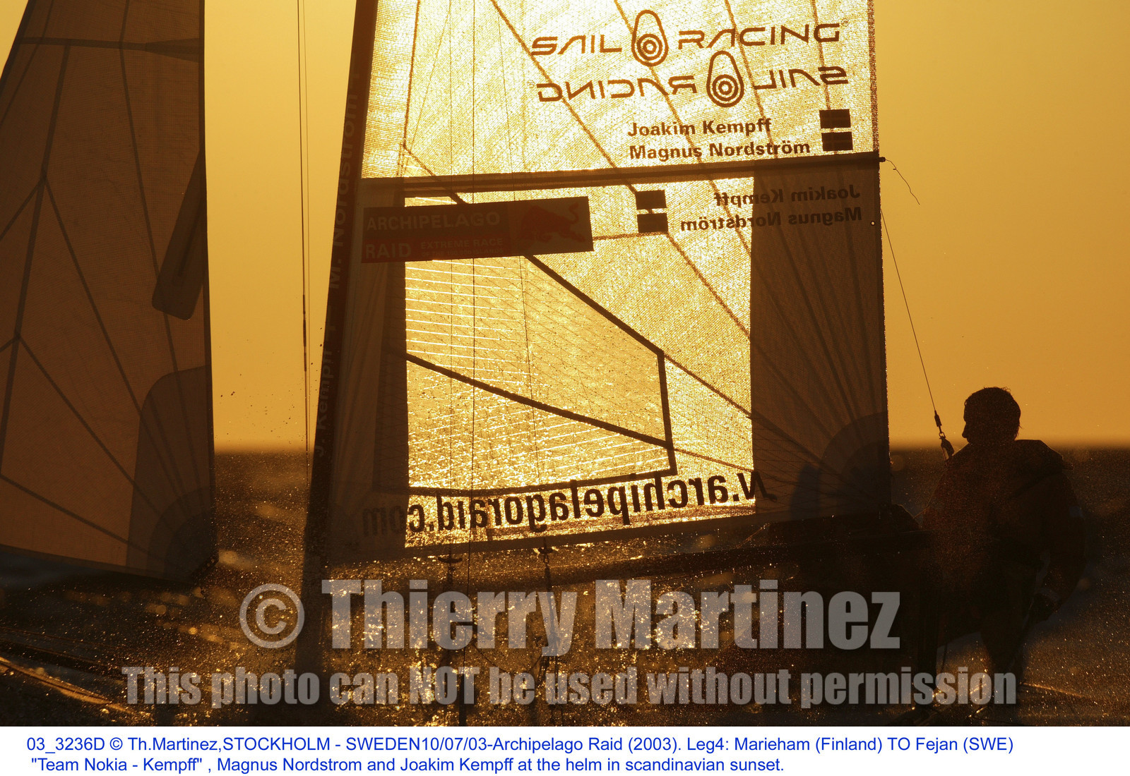 03_3236D  © Th.Martinez,STOCKHOLM - SWEDEN10 07 03-Archipelago Raid (2003). Leg4: Marieham (Finland) TO Fejan (SWE). Team Nokia - Kempff , Magnus Nordstrom and Joakim Kempff at the helm in scandinavian sunset.