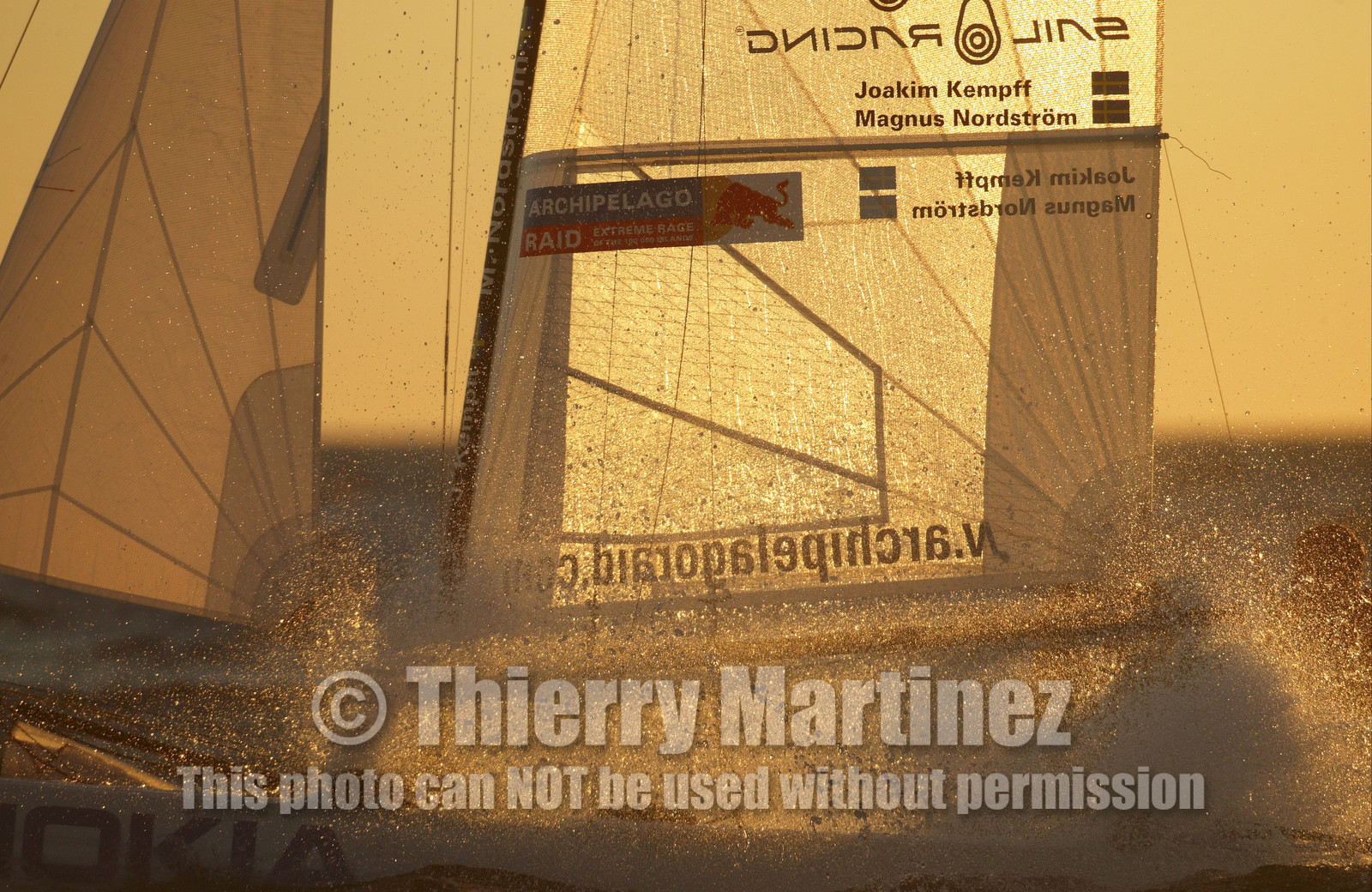 03_3238D © Th.Martinez,STOCKHOLM ARCHIPELAGO SWEDEN, 10 07 03-Archipelago Raid (2003)  Day 3..Team NOKIA-Kempff  Magnus Nordstrom (SWE)& Joakim Kempff (SWE) sailing in sunset light on the way back from Finland to Sweden.